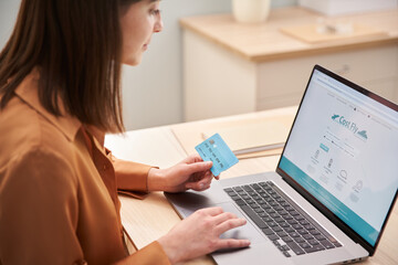 Crop female buying plane tickets online