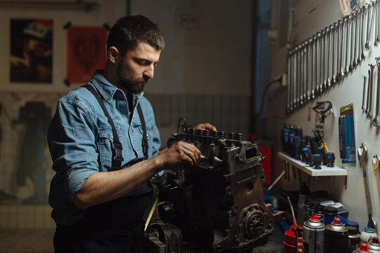 Mechanic Working On An Engine