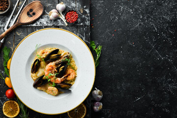 Risotto with seafood: rice, shrimp and mussels. Top view. Free space for text.