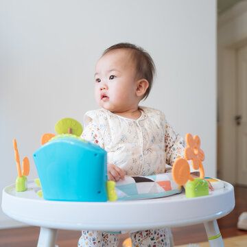 Babygirl playing at the game table bouncing bed