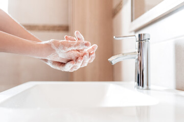 Hands being washed with soap and bubbles