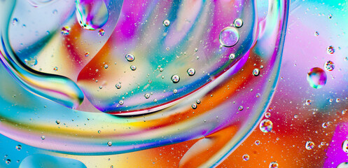 Iridescent macro background of oil drops on the water