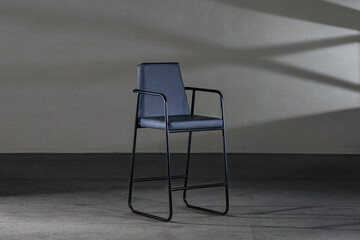 Closeup of a blue minimalist style chair with leather upholstery