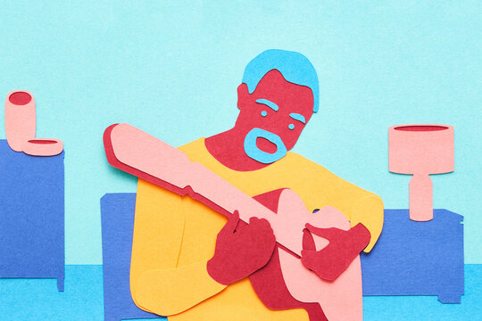 Bearded man playing guitar at home