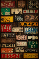 Various retro License Plates on the wooden wall.