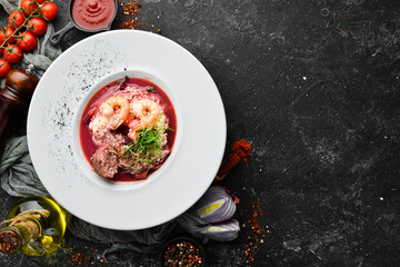 Beet soup with veal and shrimp. Couscous. Top view, free space for your text. Rustic style.