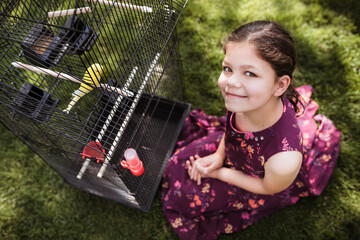 Happy girl with her yellow parrot she has just got as a gift