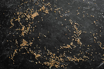 Wheat on a black stone background. Top view. Rustic style.