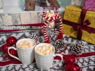 hot chocolate with small marshmallows on the blanket