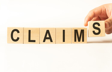 Word claims. Wooden small cubes with letters isolated on white background with copy space available