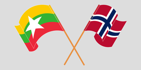 Crossed and waving flags of Myanmar and Norway