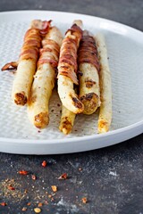 Ripe baked asparagus with bacon, side dish for breakfast, lunch, barbecue.