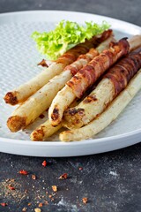 Ripe baked asparagus with bacon, side dish for breakfast, lunch, barbecue.