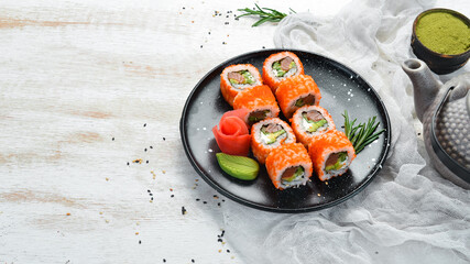Sushi set with caviar, avocado and salmon. Asian cuisine. Top view. Free space for your text.