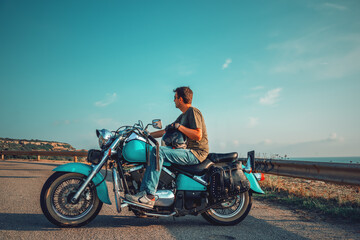 Biker on a classic motorcycle by the sea