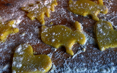Shortbread cookies of different shapes on a wooden table with flour. Cooking, baking.