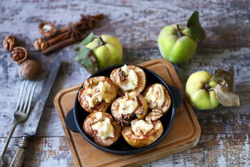 Baked quince with sweet cheese. Autumn dessert. Selective focus. Macro.