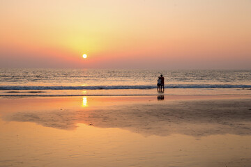 Idyllic pink scene of landscape with Pair  together, Indian Ocean and sunset