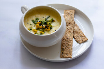 Chilled sweetcorn soup with avocado and coriander salsa