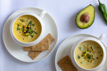 Chilled sweetcorn soup with avocado and coriander salsa