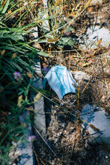 Obraz premium View of a surgical mask to protect against the coronavirus thrown in the streets of Reims, a city in the Grand Est region of France