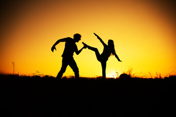 Aggression and abuse concept. Man and woman expressing domestic violence. Sunset. 