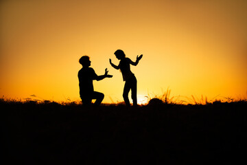 Fototapeta na wymiar Silhouettes of couple man and woman In Nature sunset. Couple love concept. 