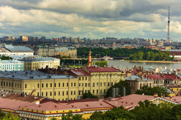 Fototapeta premium View of the Admiralty building and the Kunstkamera Museum on Vasilievsky Island from the colonnade of St. Isaac's Cathedral in St. Petersburg, Russia