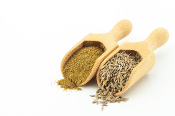 Dry cumin seeds with ground caraway powder isolated on white background. Healthy food cumin spice...