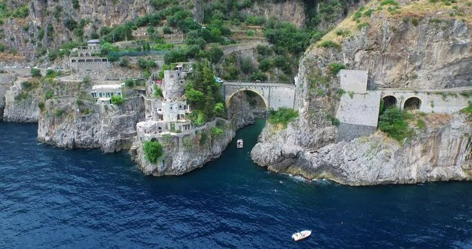 Crowded beach under Furore Bridge on Amalfi Coast, aerial