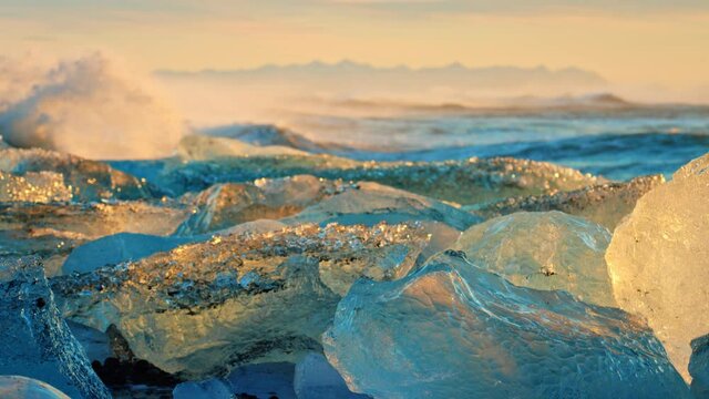 Slow motion, Iceland beach covered in ice at sunset
