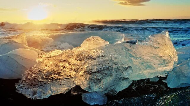 Sunset over icy beach in Iceland, slow motion close up