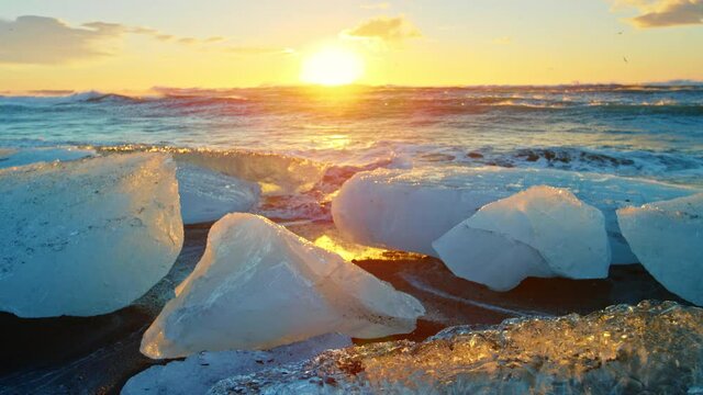 Okulsarlon Beach covered in ice at sunset, slow motion