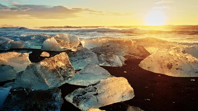 Iceland beach covered in ice during sunset, slow motion close up
