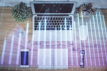 Multi exposure of financial chart drawing over table background with computer. Concept of research....