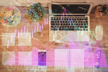 Stock market graph and top view computer on the table background. Multi exposure. Concept of financial education.