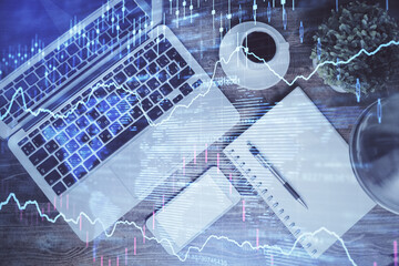 Financial market graph and top view computer on the desktop background. Double exposure. Investment concept.