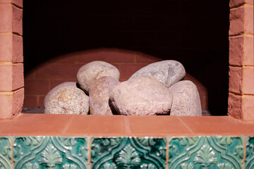 a brick oven with stones inside, without fire