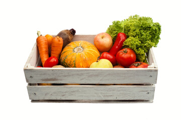 crop vegetables pumpkin tomato carrots beet apples potato hot pepper green lettuce in a white wooden box isolated on a white background