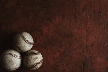 Baseball game balls on red texture background.