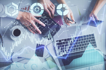 Double exposure of man and woman working together and financial chart hologram drawing. market analysis concept. Computer background. Top View.