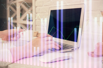 Double exposure of woman hands typing on computer and forex chart hologram drawing. Stock market...