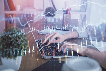 Double exposure of woman hands typing on computer and forex chart hologram drawing. Stock market invest concept.