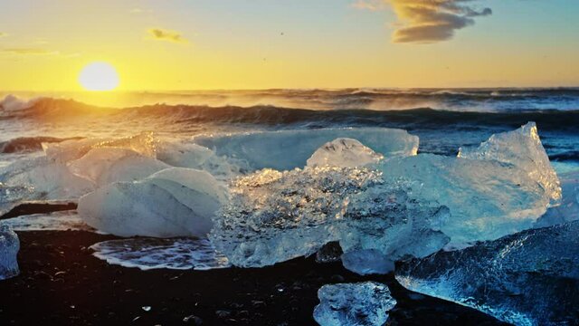 Sunset over icebergs on Okulsarlon Beach, close up