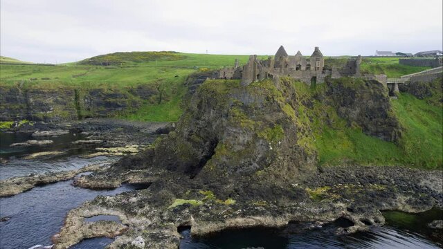 Panning aerial, castle ruins on Ireland coastline
