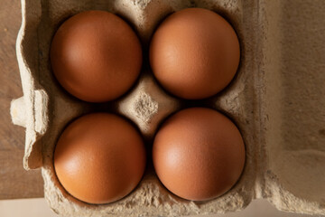 four Eggs are in a cardboard box close-up. Food for the home. The food for restaurant