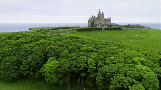 Wide panning aerial, old castle landmark in Ireland