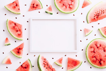 Empty frame for text and sliced watermelon around it. Summer concept. Flat lay, top view, copy space