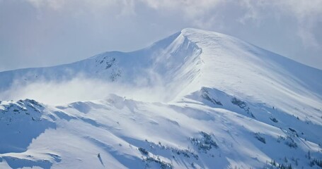 Pan left aerial, Banff National Park mountain range in winter - Powered by Adobe