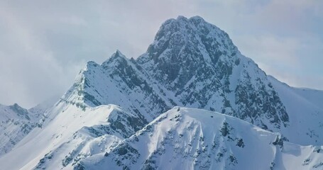 Pan left aerial, snowy mountain in Banff National Park